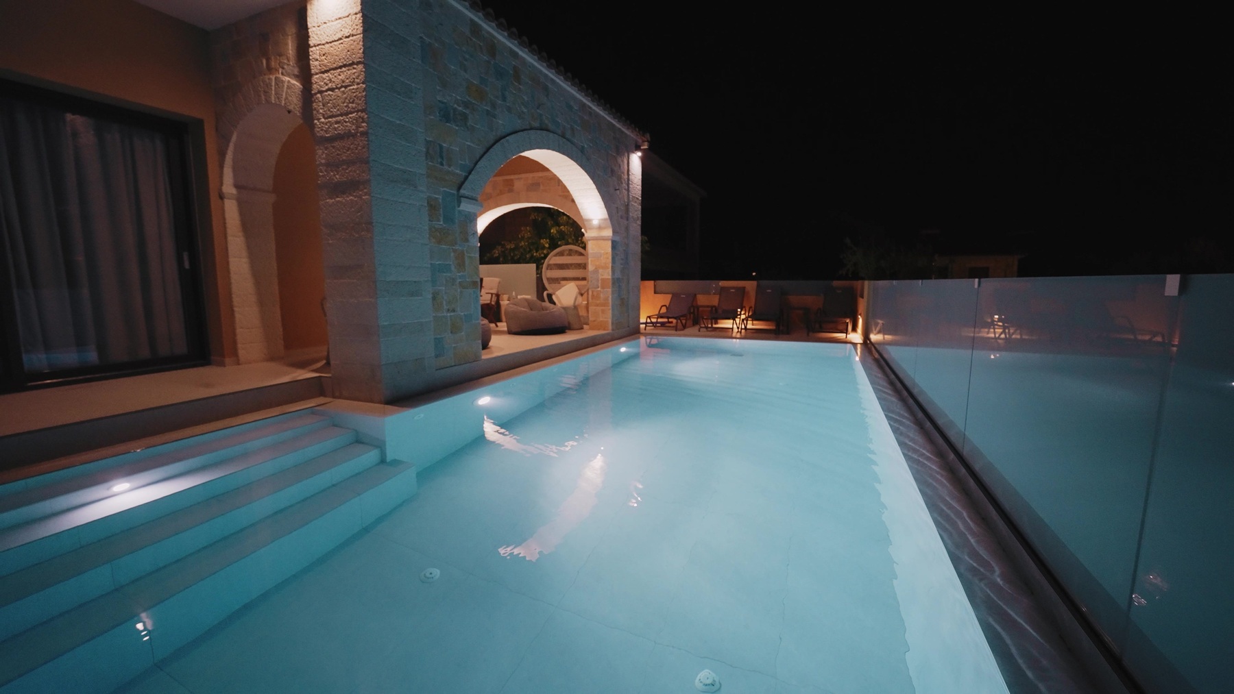 Romanza Villa II pool glowing at night